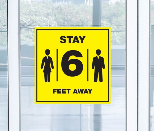 Stay 6 feet away reminder sign in yellow and black