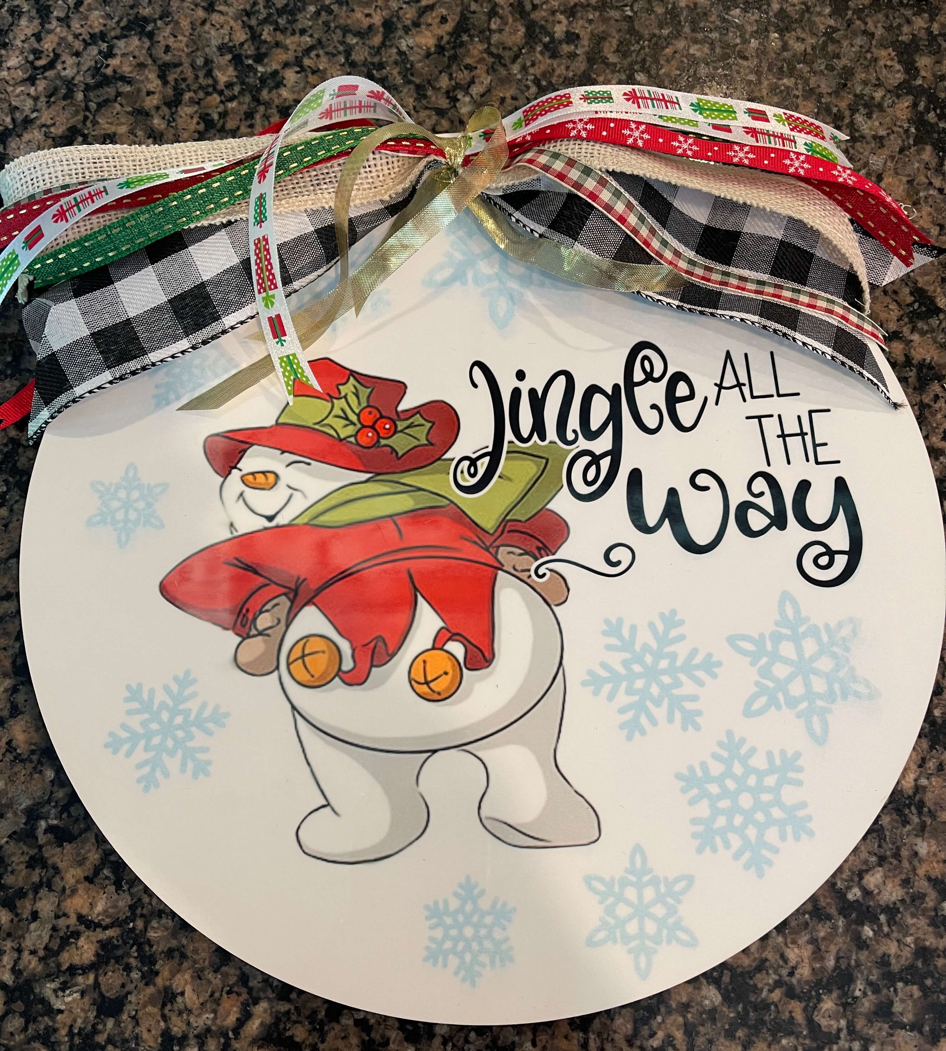 Large round home decor personalized with a snowman, "Jingle all the way" and a ribbon