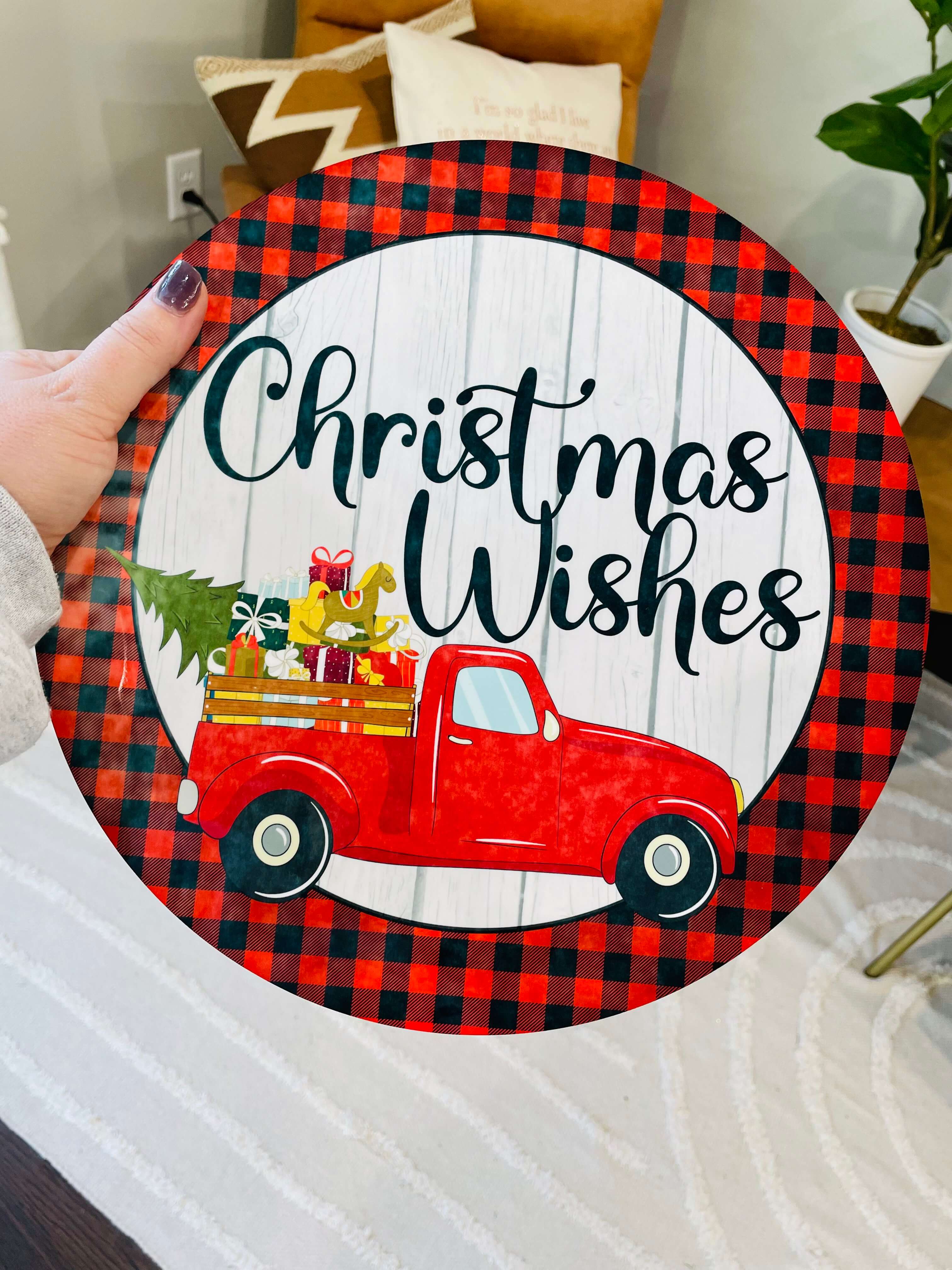Home decor round personalized with a truck hauling a tree and "Christmas Wishes" above the truck