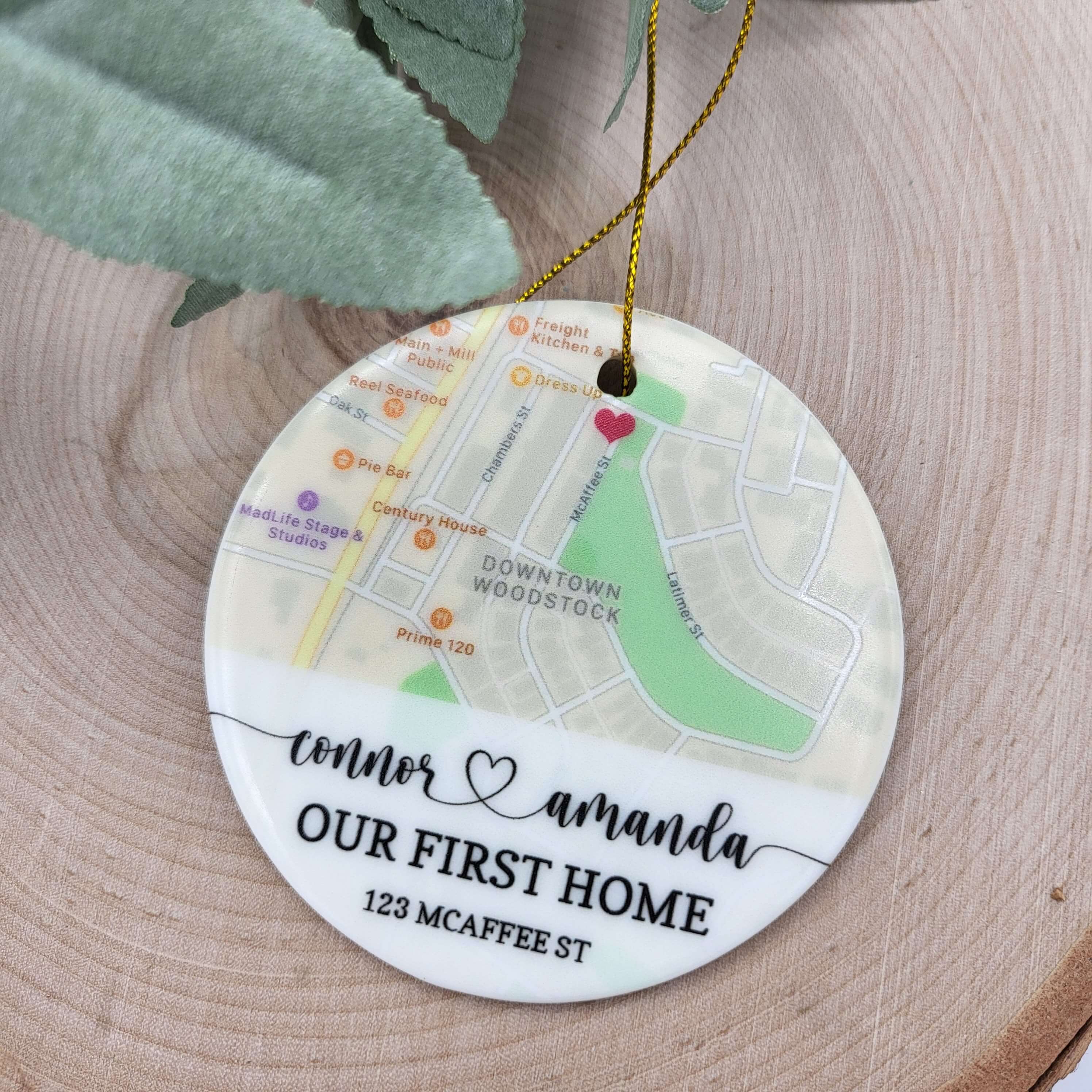 Ceramic round ornament personalized with a map image, "Our First Home", the names of the couple and an address