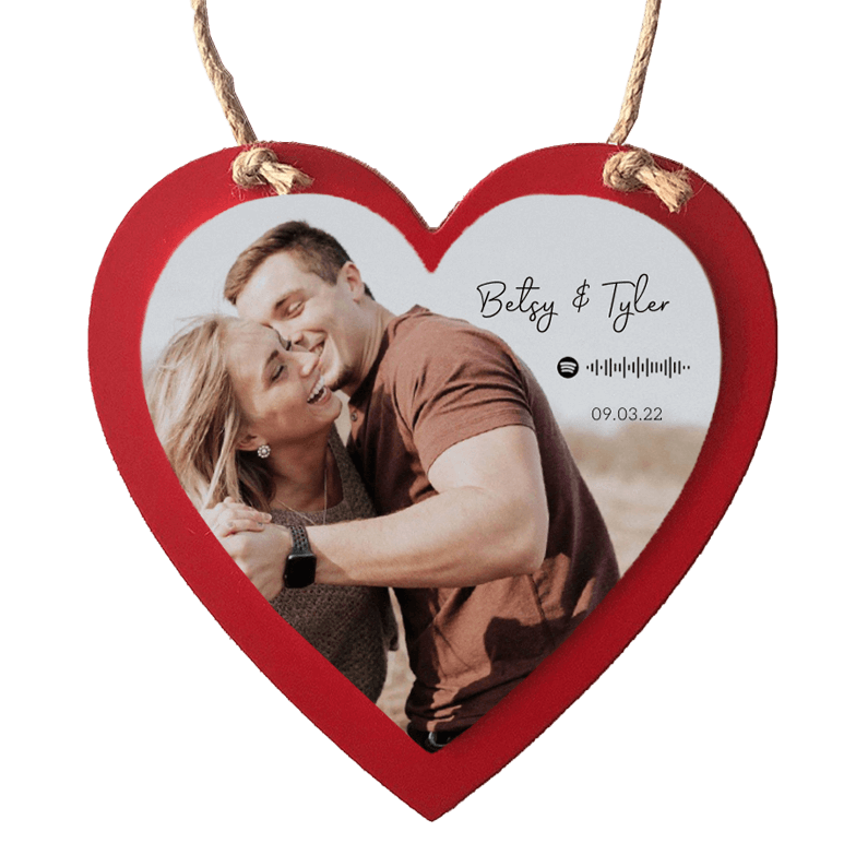 Red wooden heart ornament with image of couple.