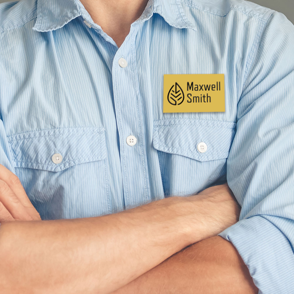 Man wearing gold Maxwell Smith nametag