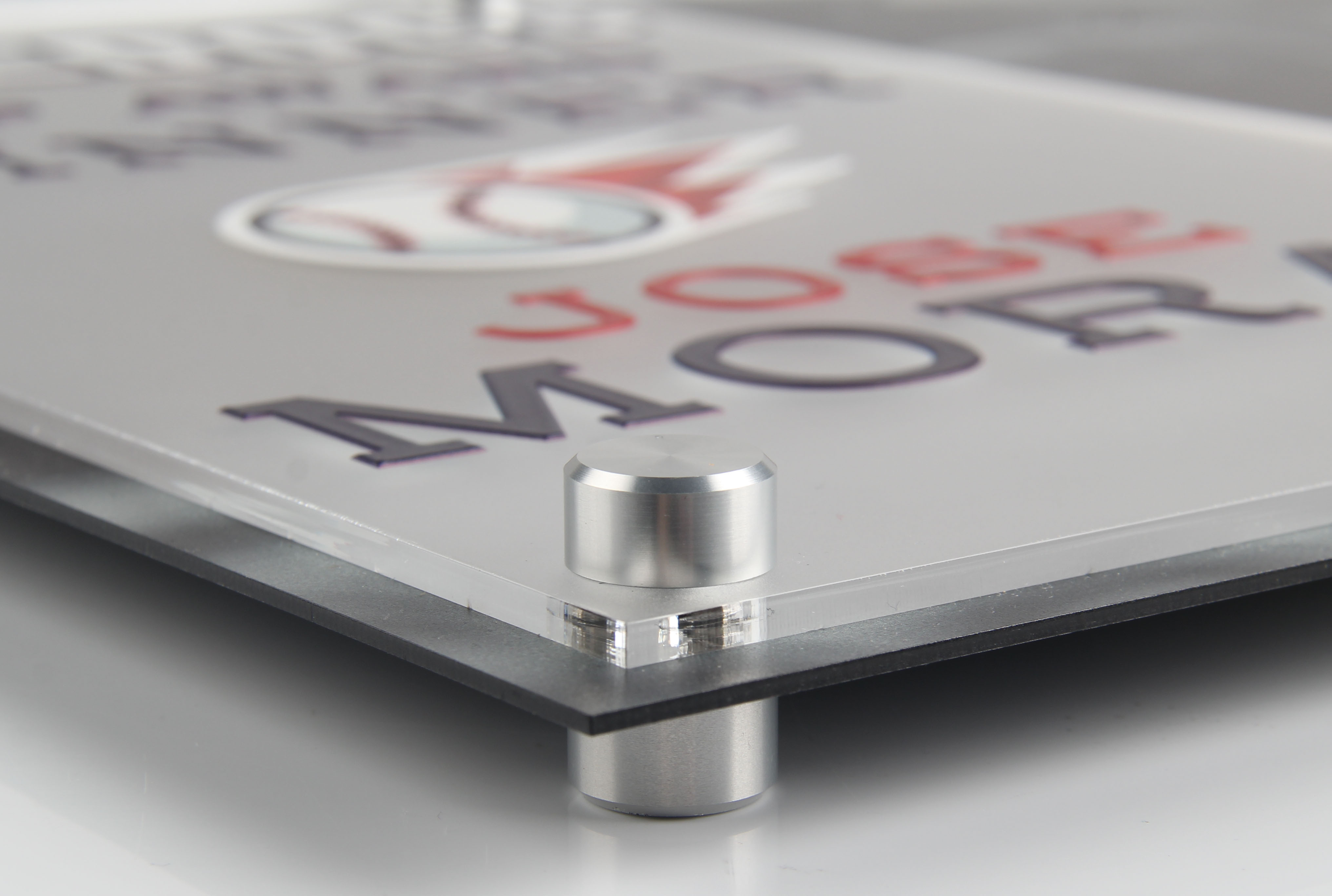 Close up on the corner of a sign to show the mounting hardware