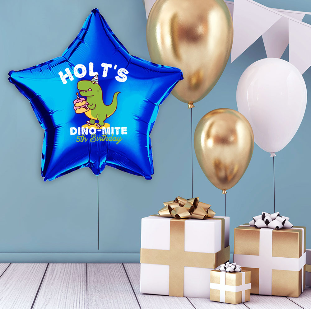 customized mylar balloon next to a stack of presents with other balloons